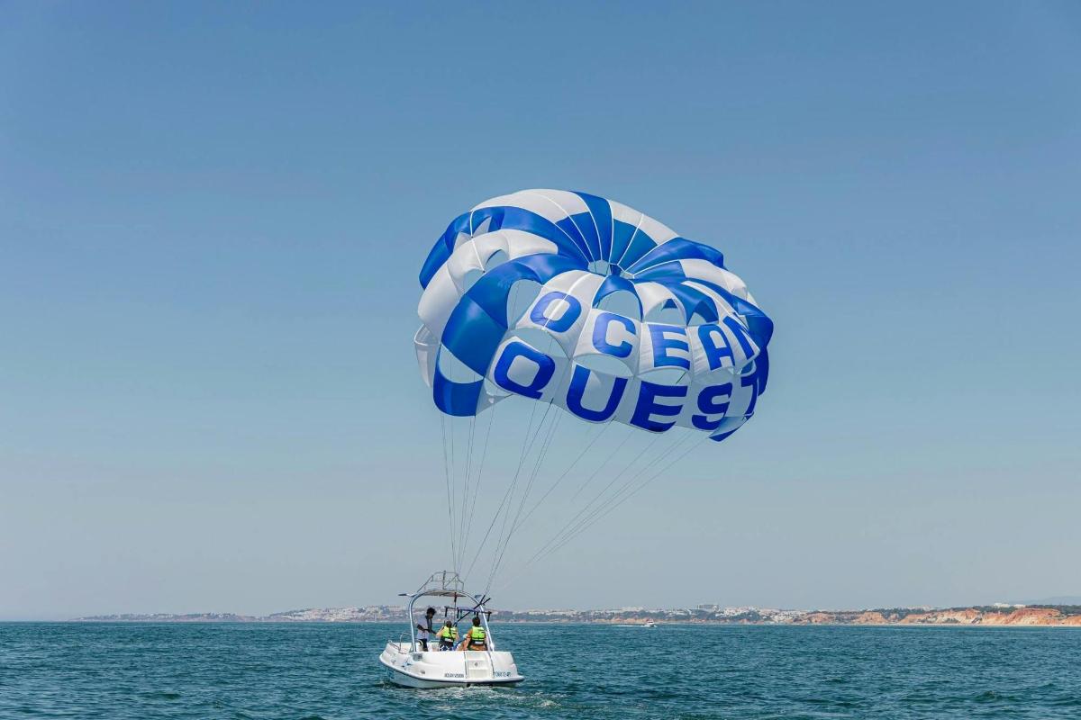 a large blue and white parachute in the water