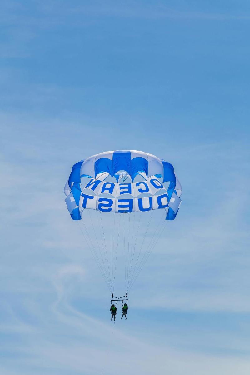 two people riding a parachute in the sky