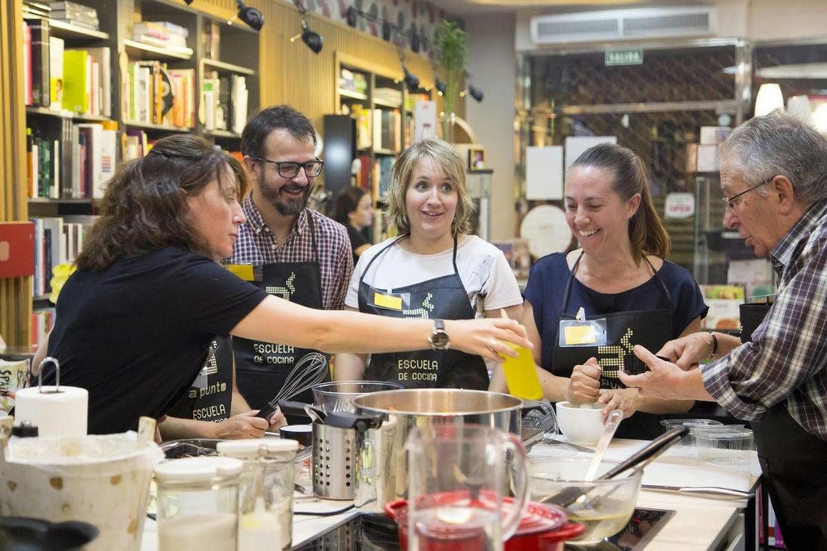 a group of people standing around a counter in a store