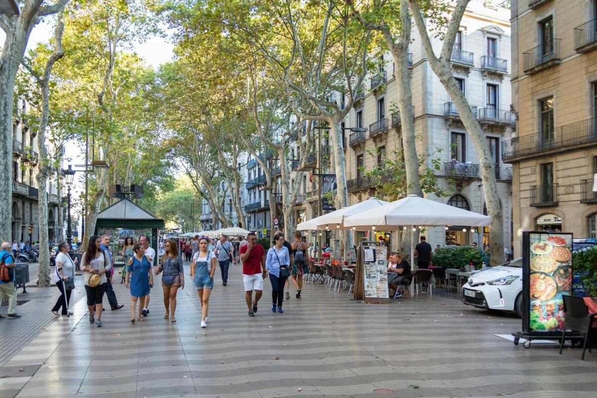 a group of people walking down a city street