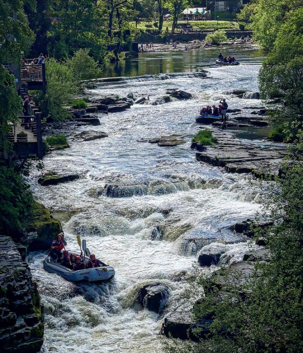 a group of people in a raft in a river