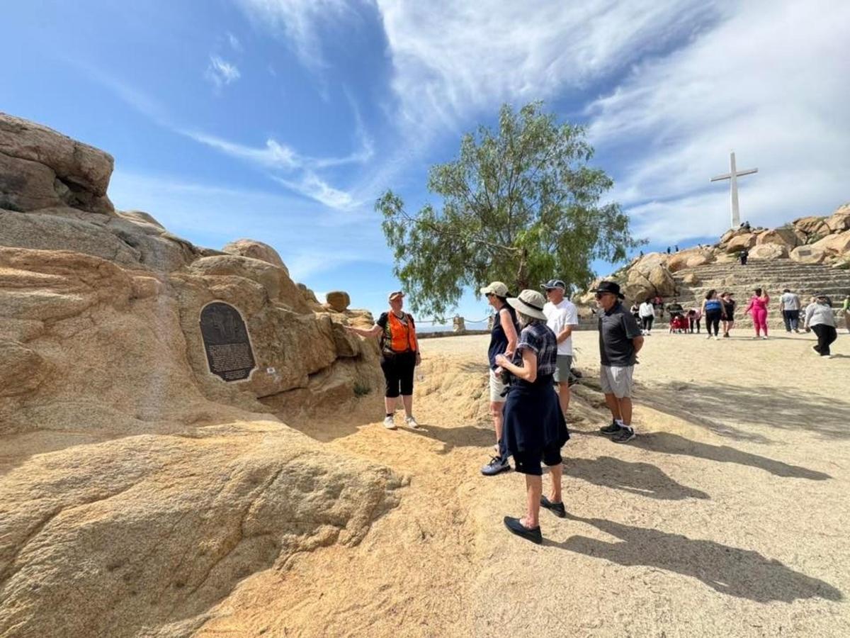 a group of people looking at a rock formation