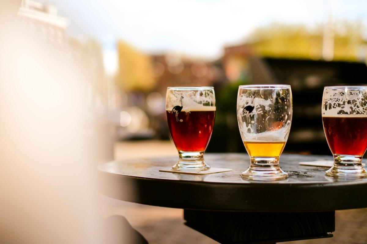 three glasses of beer sitting on a table