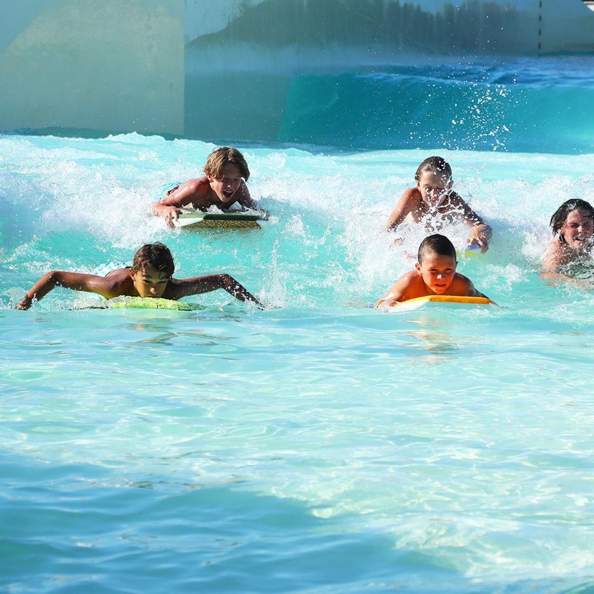 a group of children on surfboards in the water