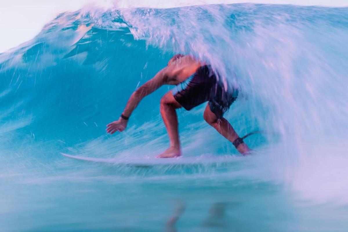 a man riding a wave on a surfboard in the ocean
