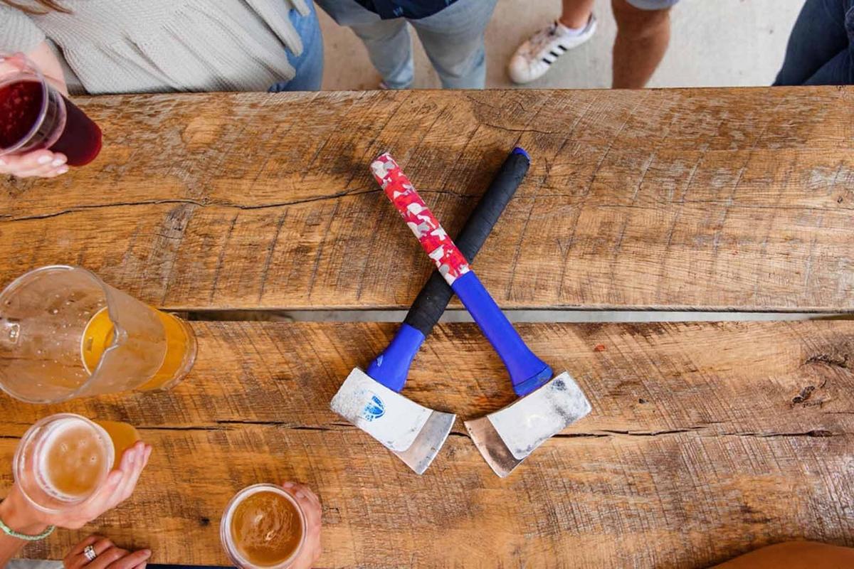two baseball bats on a wooden table with drinks