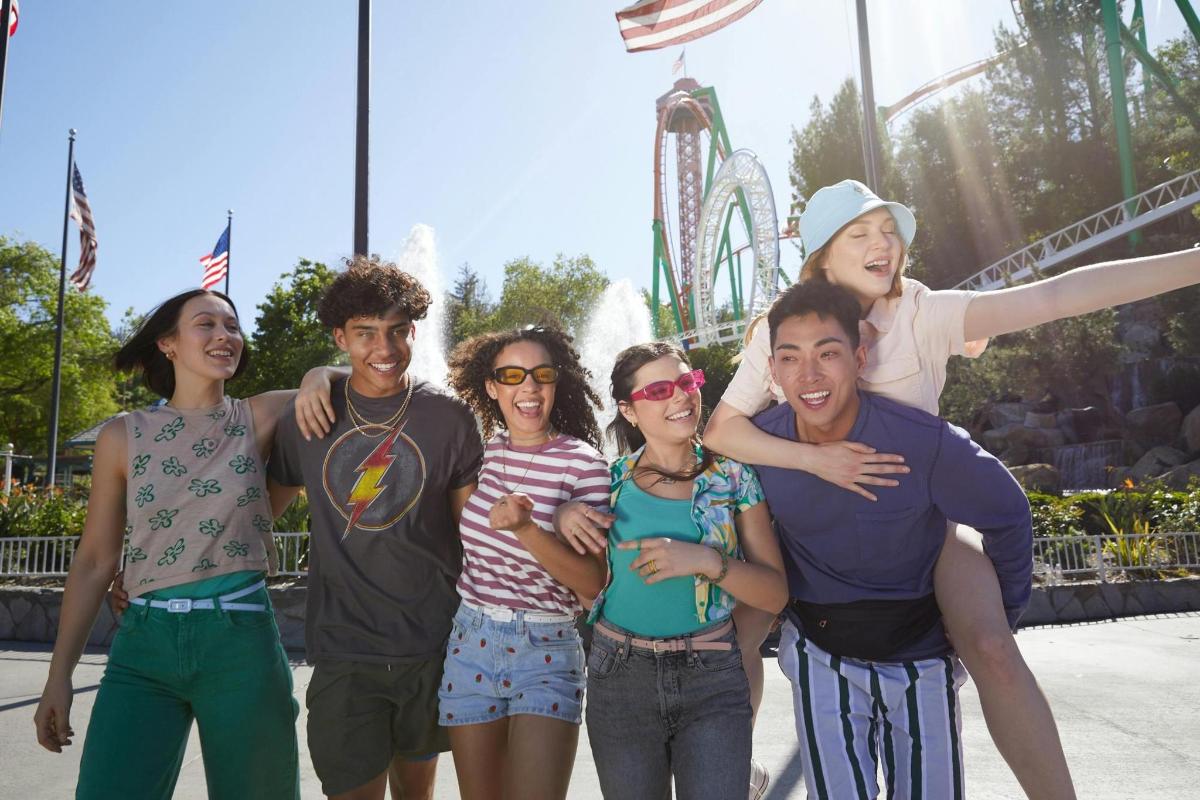 a group of people posing for a picture at an amusement park