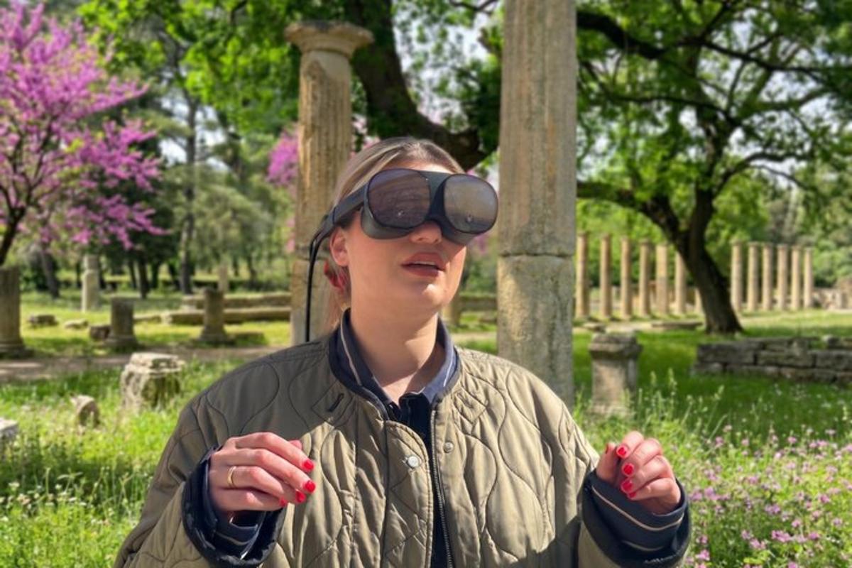 a woman with goggles on her head standing in a cemetery