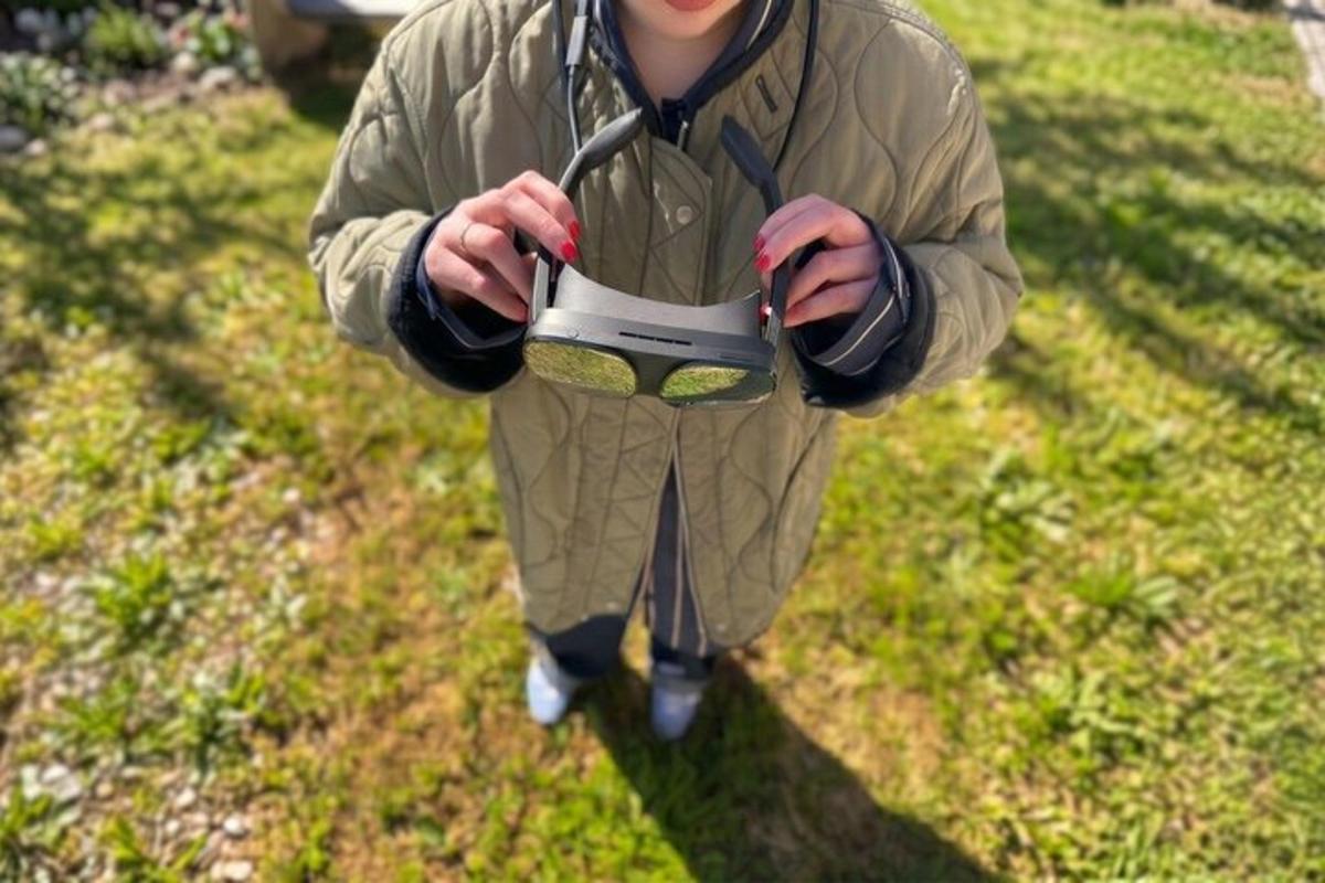 a man is holding a pair of scissors in the grass