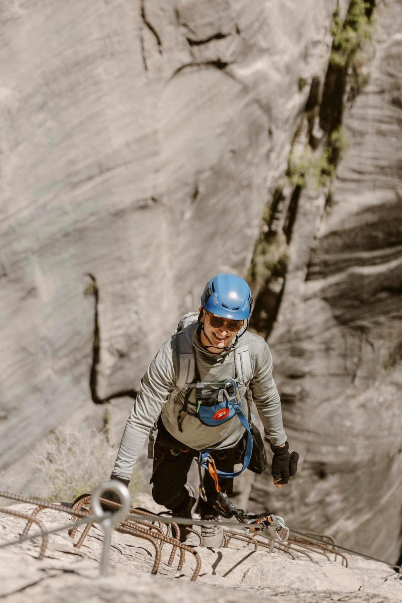 a man on skis in front of a rock wall