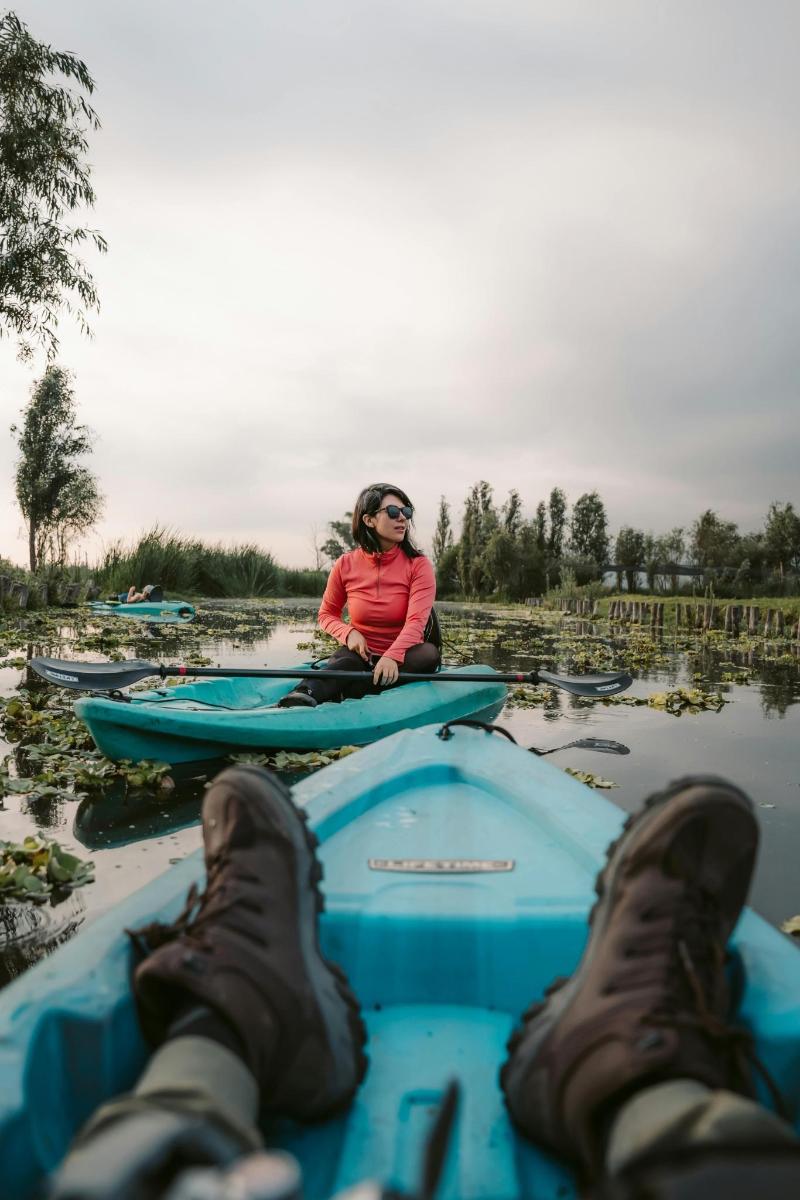 a woman sitting on a boat in the water