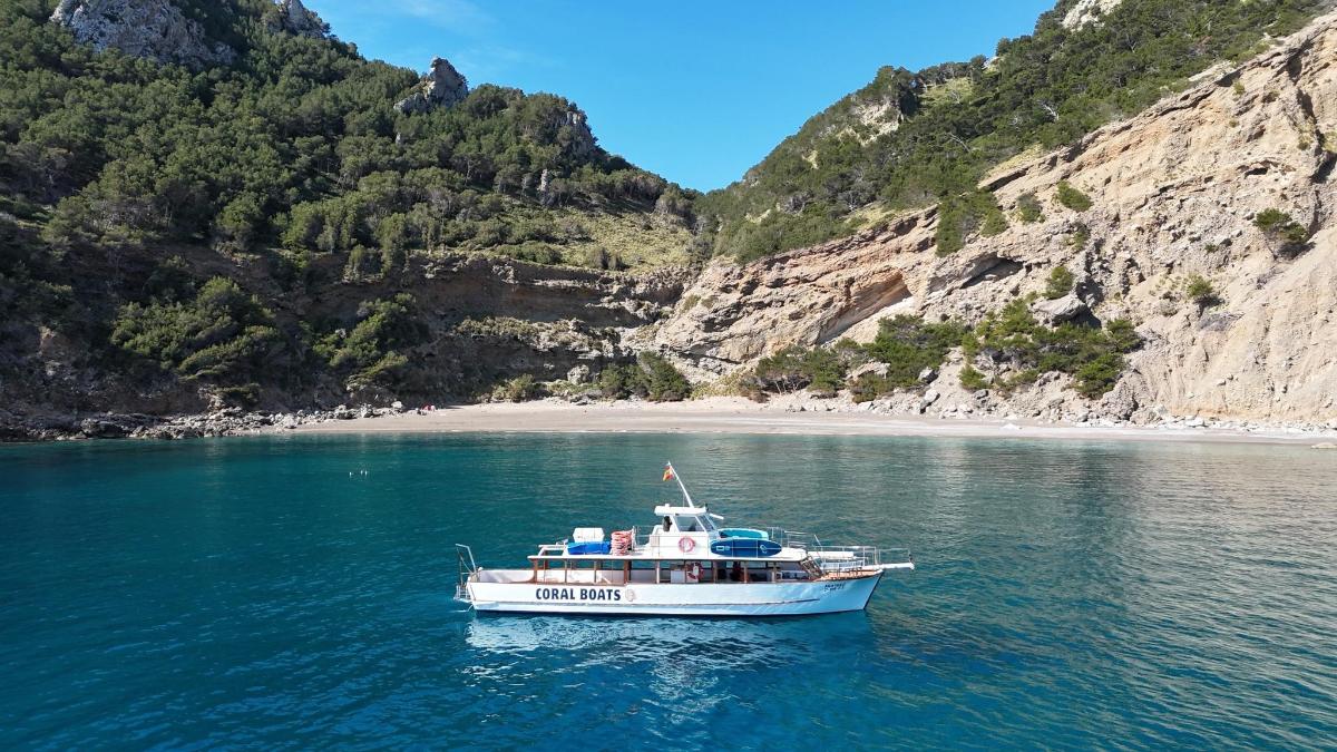 a boat in the water next to a beach