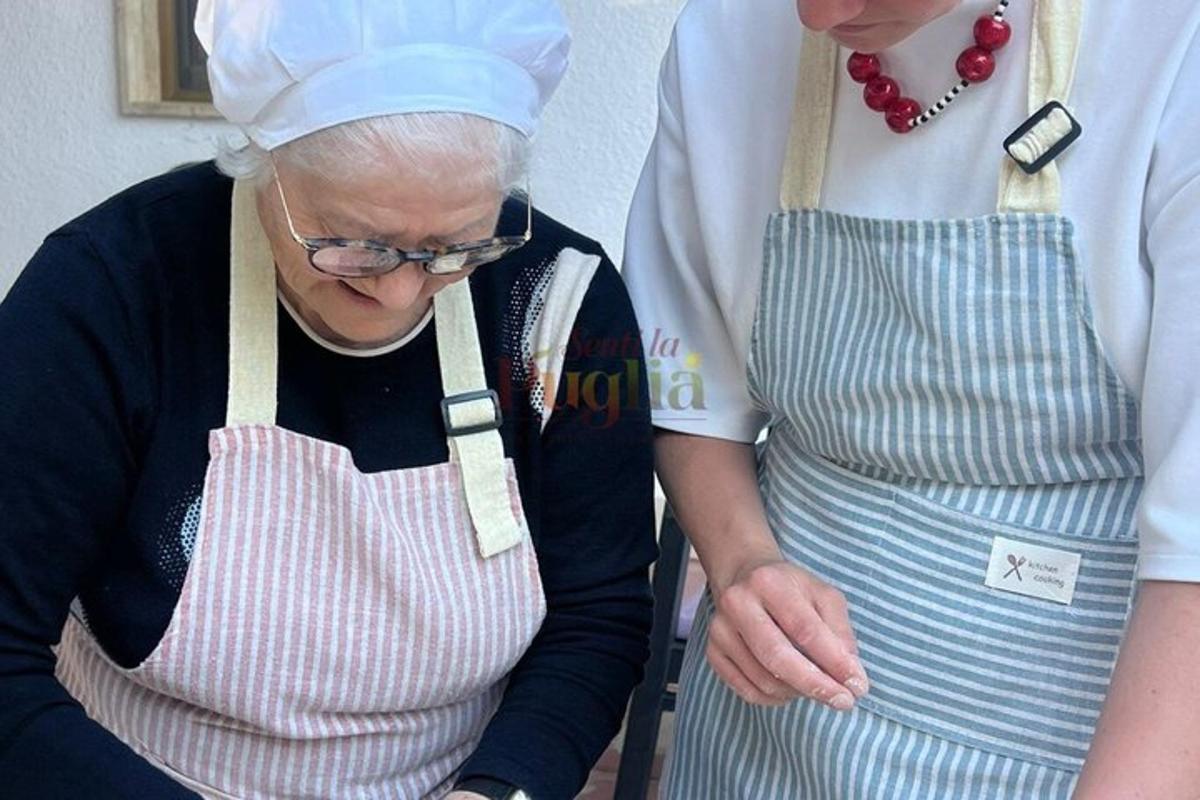 an older woman standing next to a woman in a kitchen