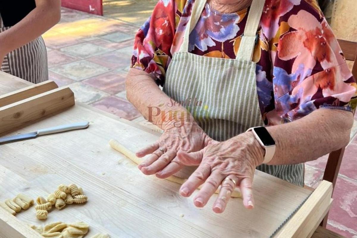 a man in an apron preparing food on a table