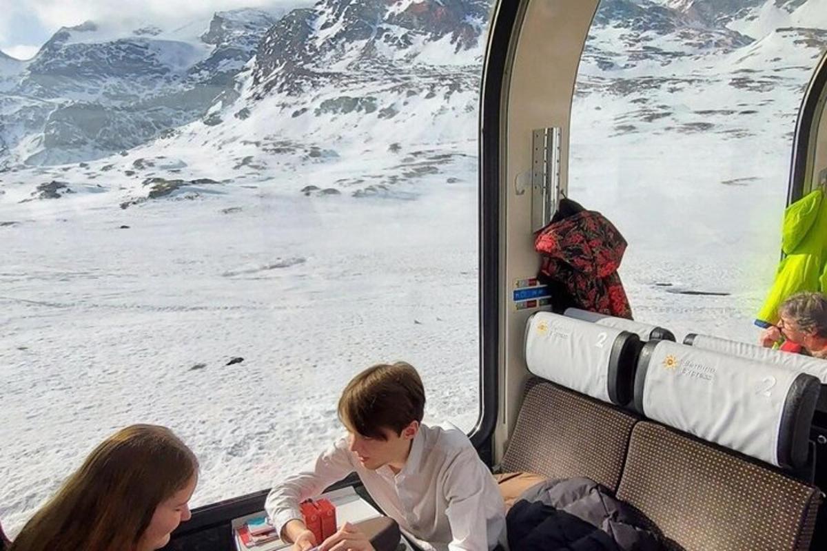 a group of children sitting on a train looking out a window