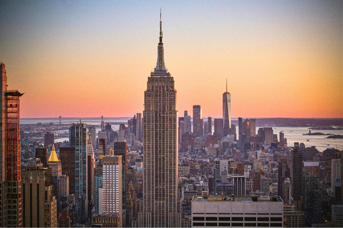 a view of the empire state building at sunset