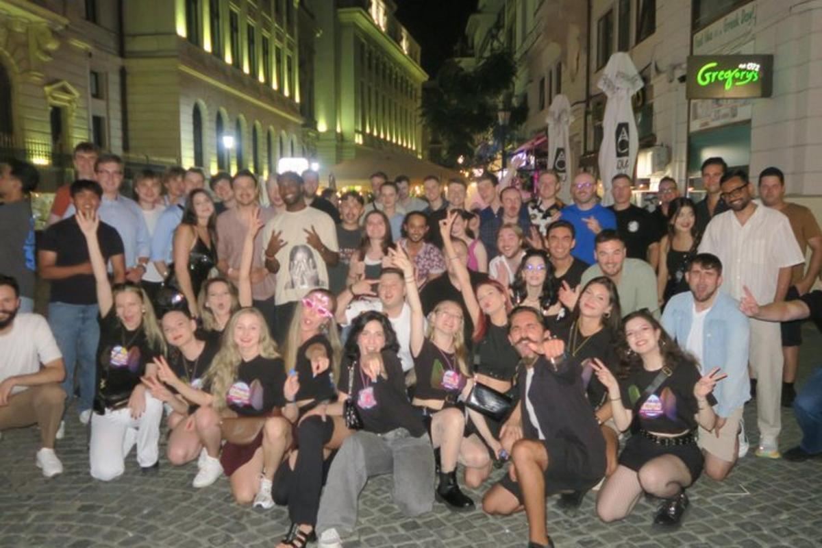 a large group of people posing for a picture on a street
