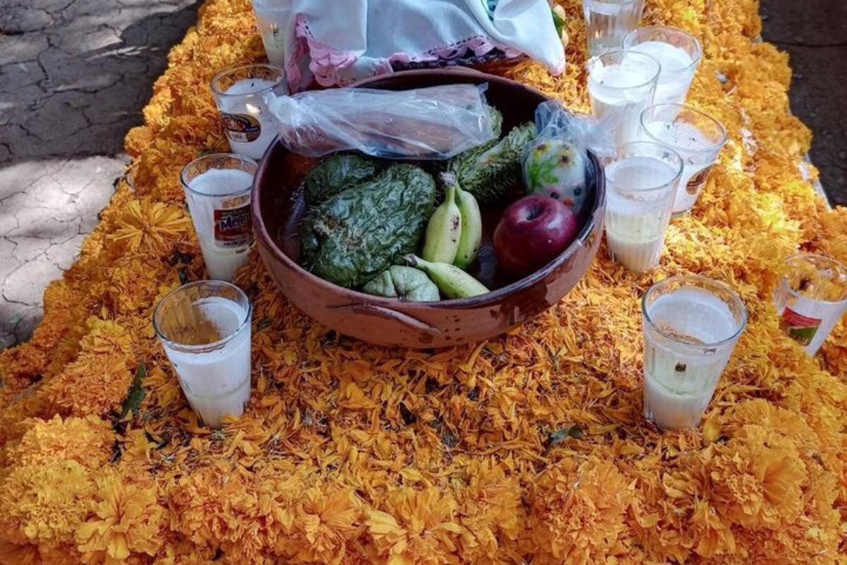 a table with a basket of vegetables and glasses of water
