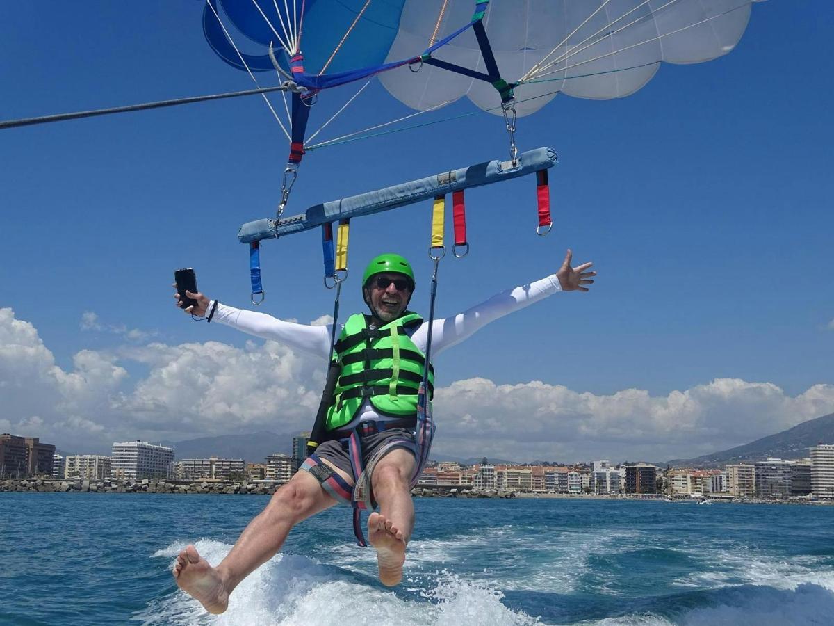 a man is holding onto a parasail in the water