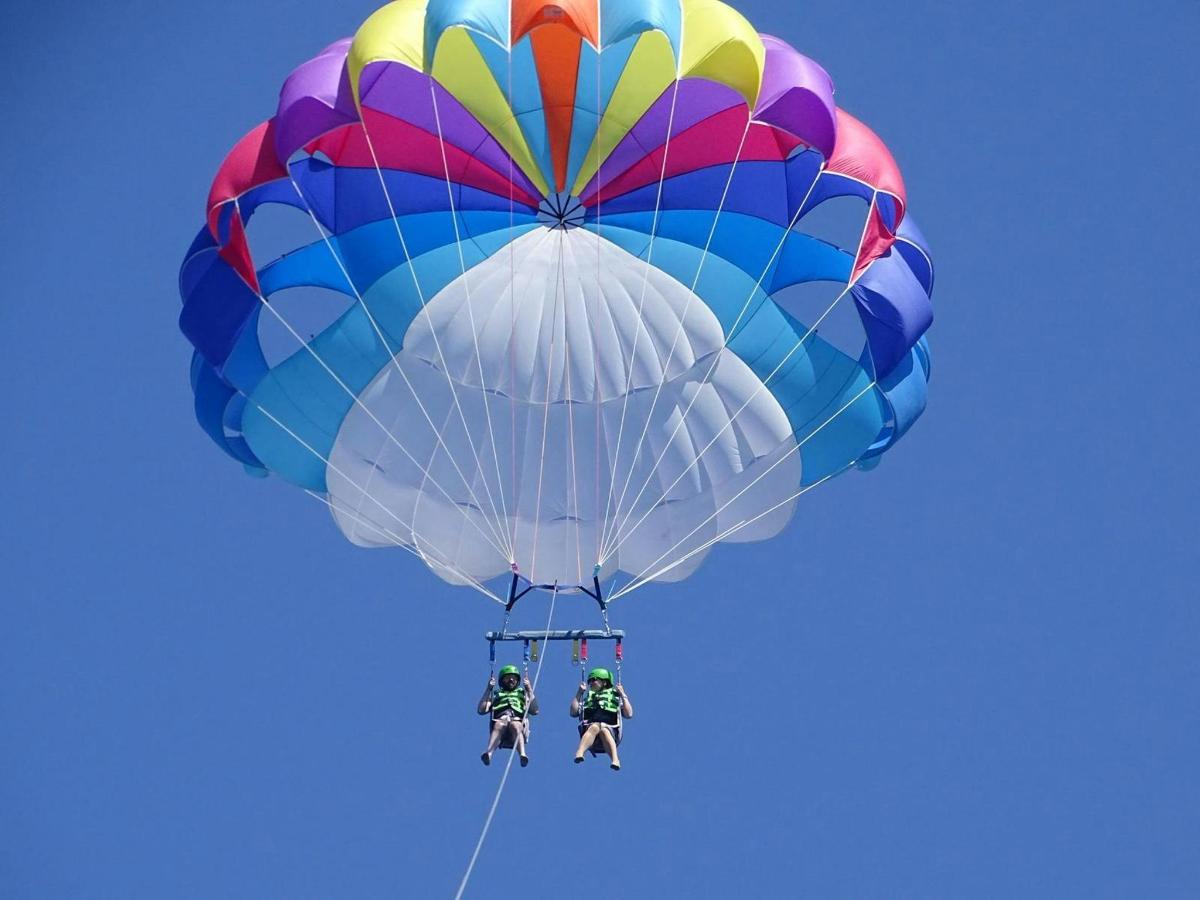 two people on a parachute in the sky