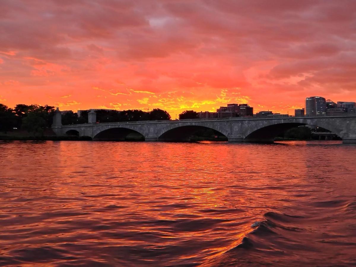 a bridge over a body of water with a sunset