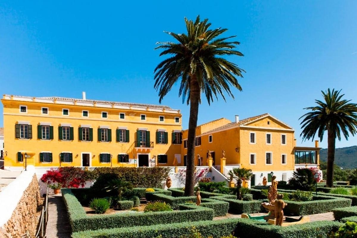 a building with a palm tree and a garden