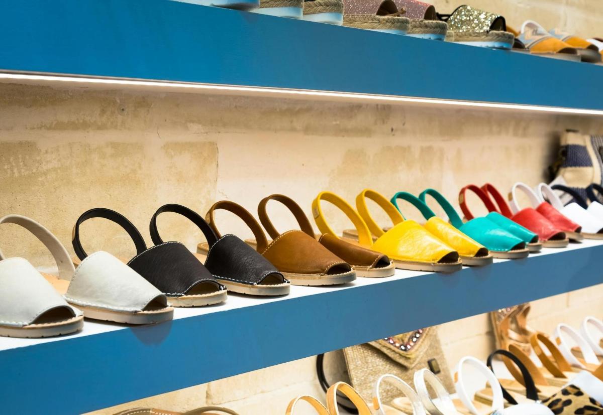 a row of shoes on shelves in a store