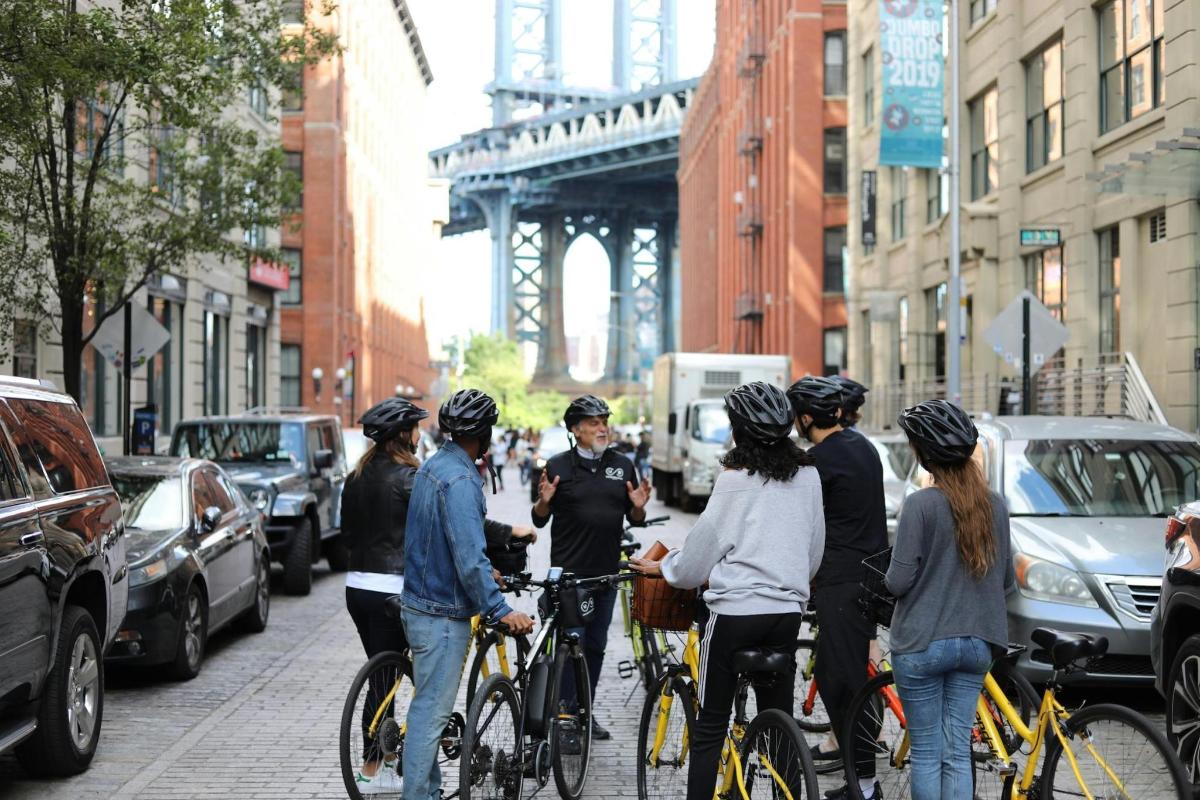 a group of people on bikes on a city street