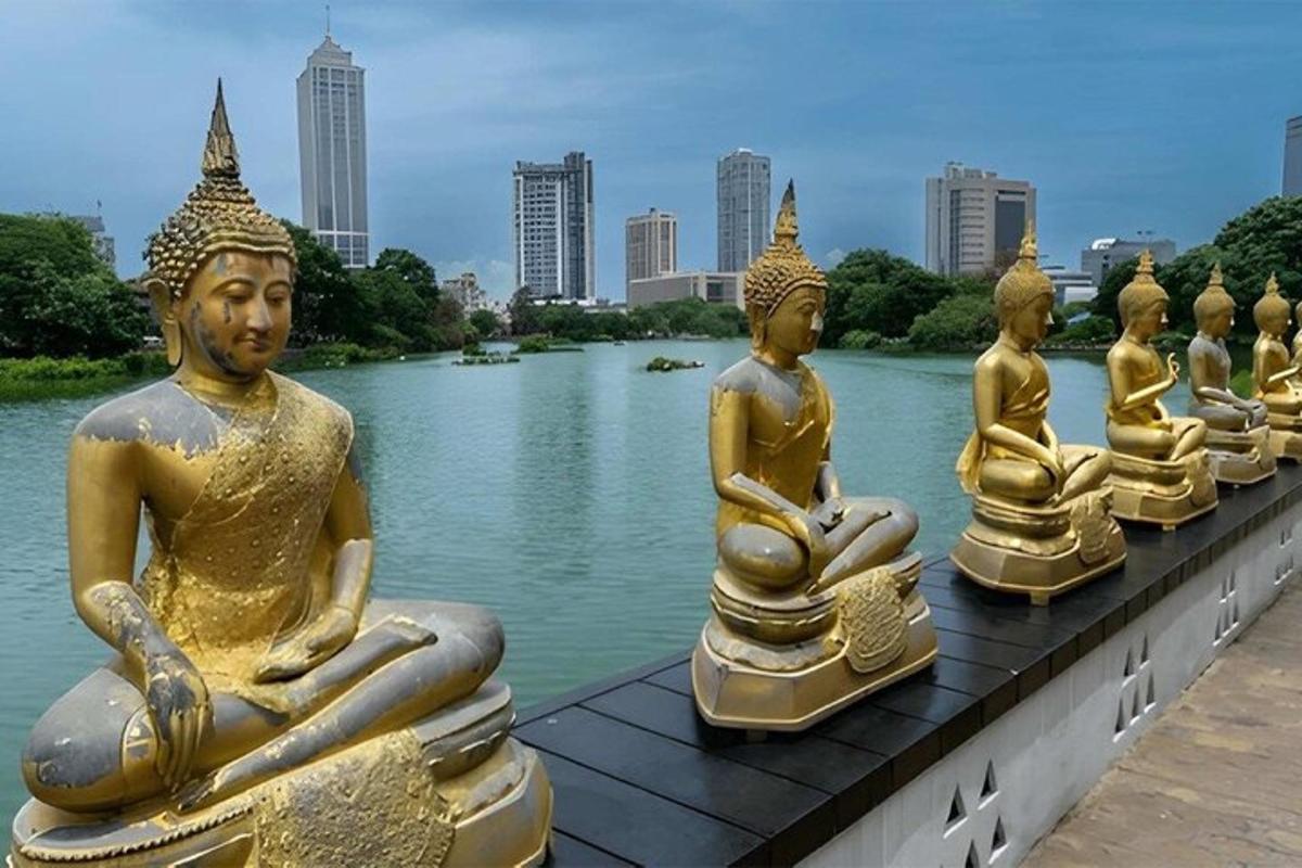 a row of golden statues sitting in the water