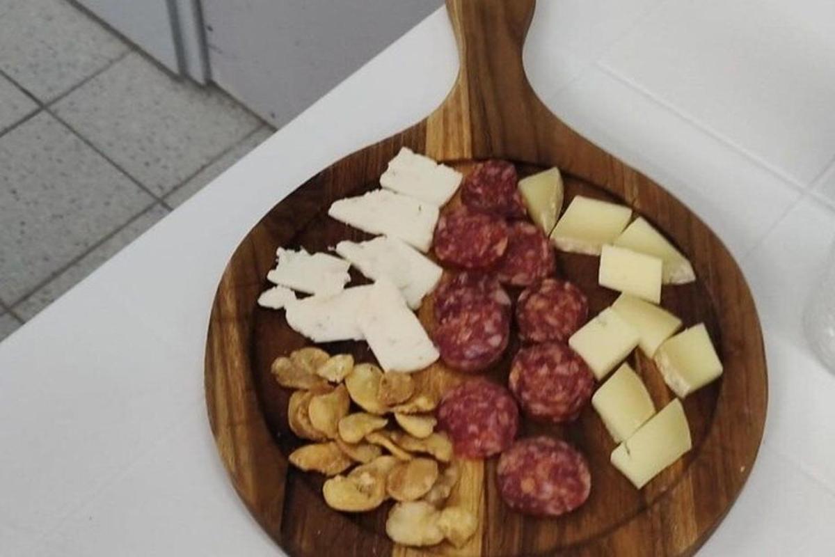 a plate of food with cheese and nuts on a table
