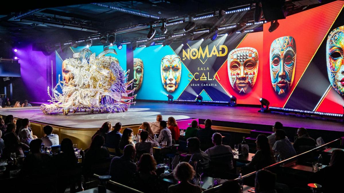 a group of people sitting on a stage with a show