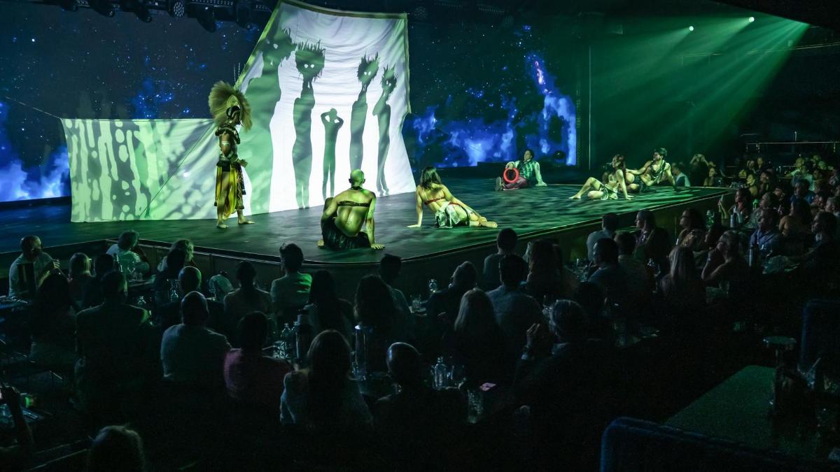 an audience watching a show in front of a stage