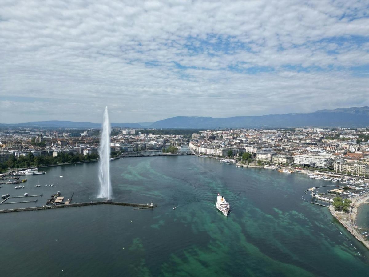 a boat in the water with a fountain in a city