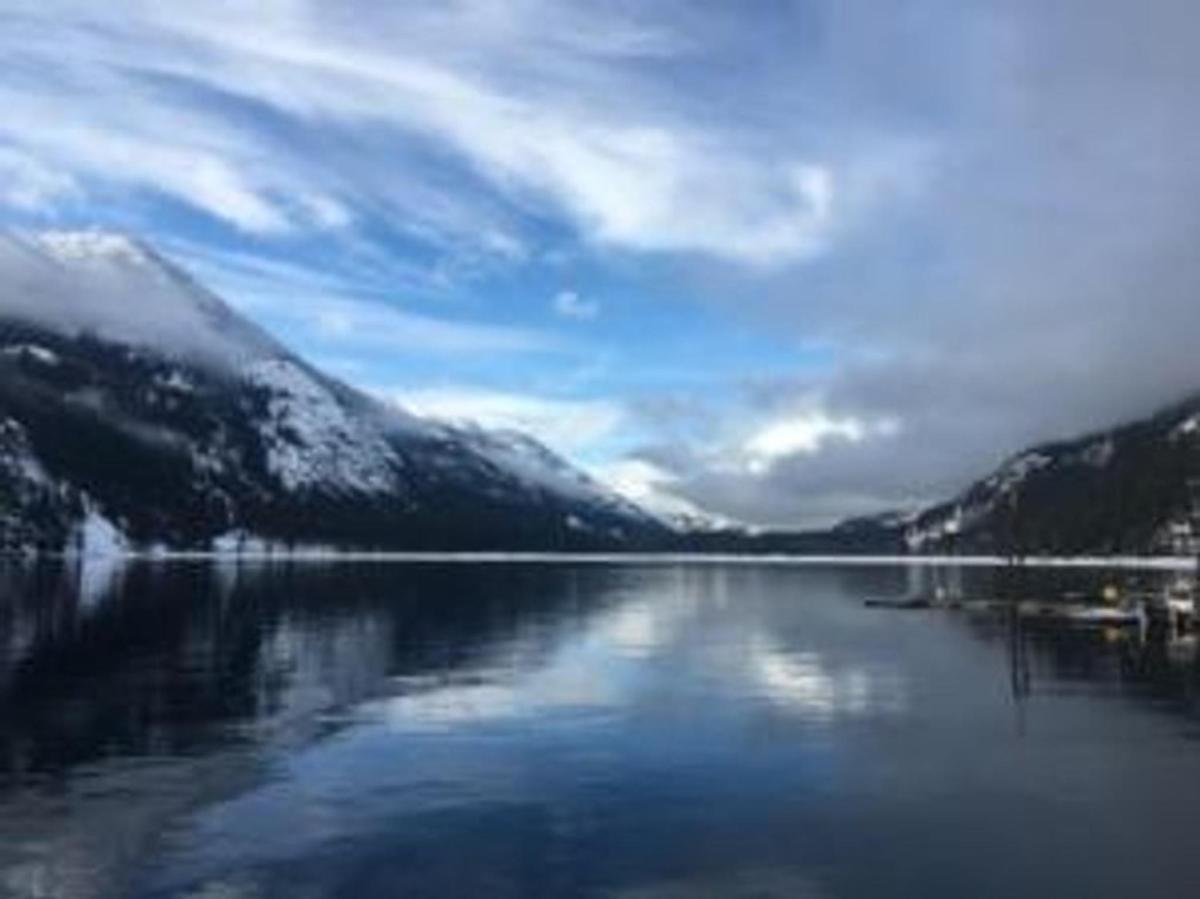 a view of a lake with snow covered mountains
