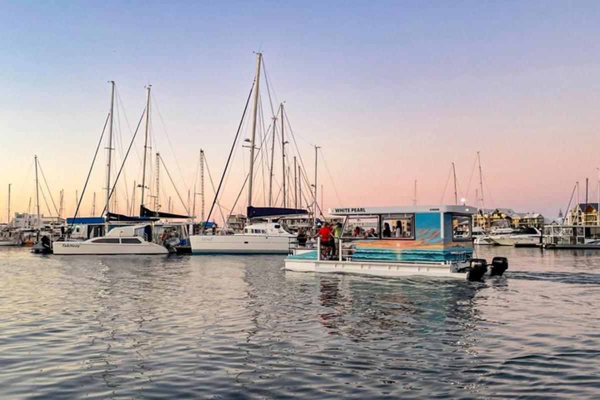 a small boat in the water with other boats