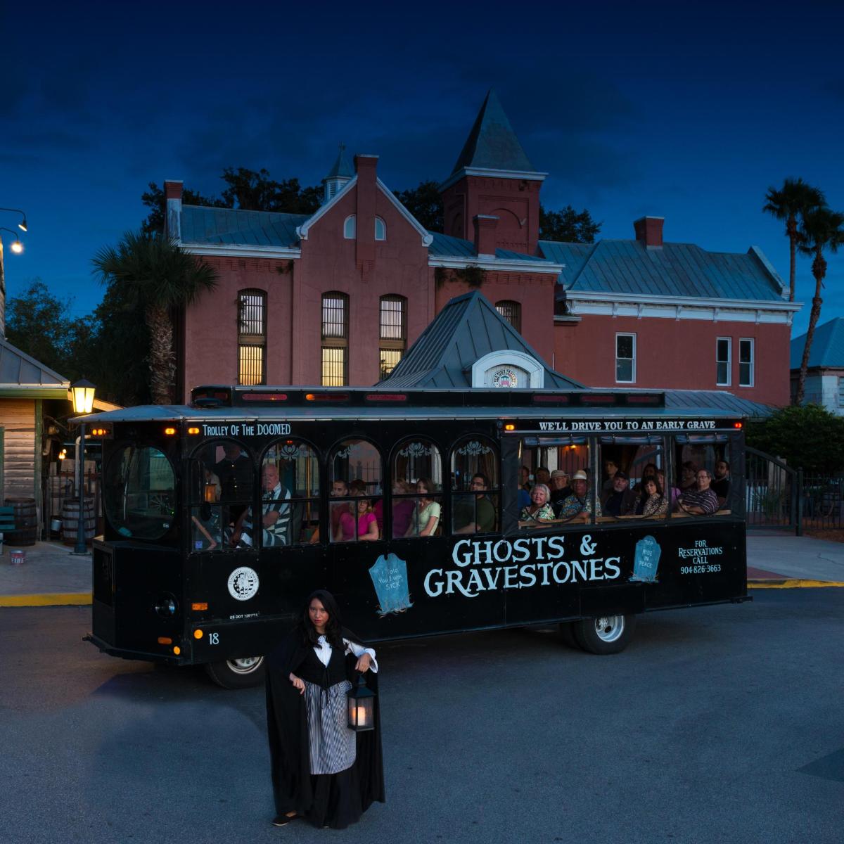a woman is standing in front of a bus