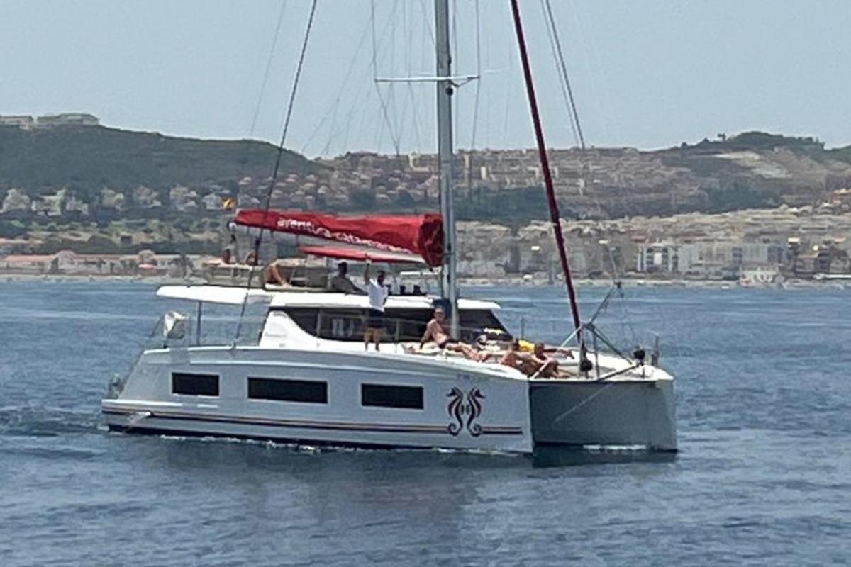 a white boat in the water with people on it