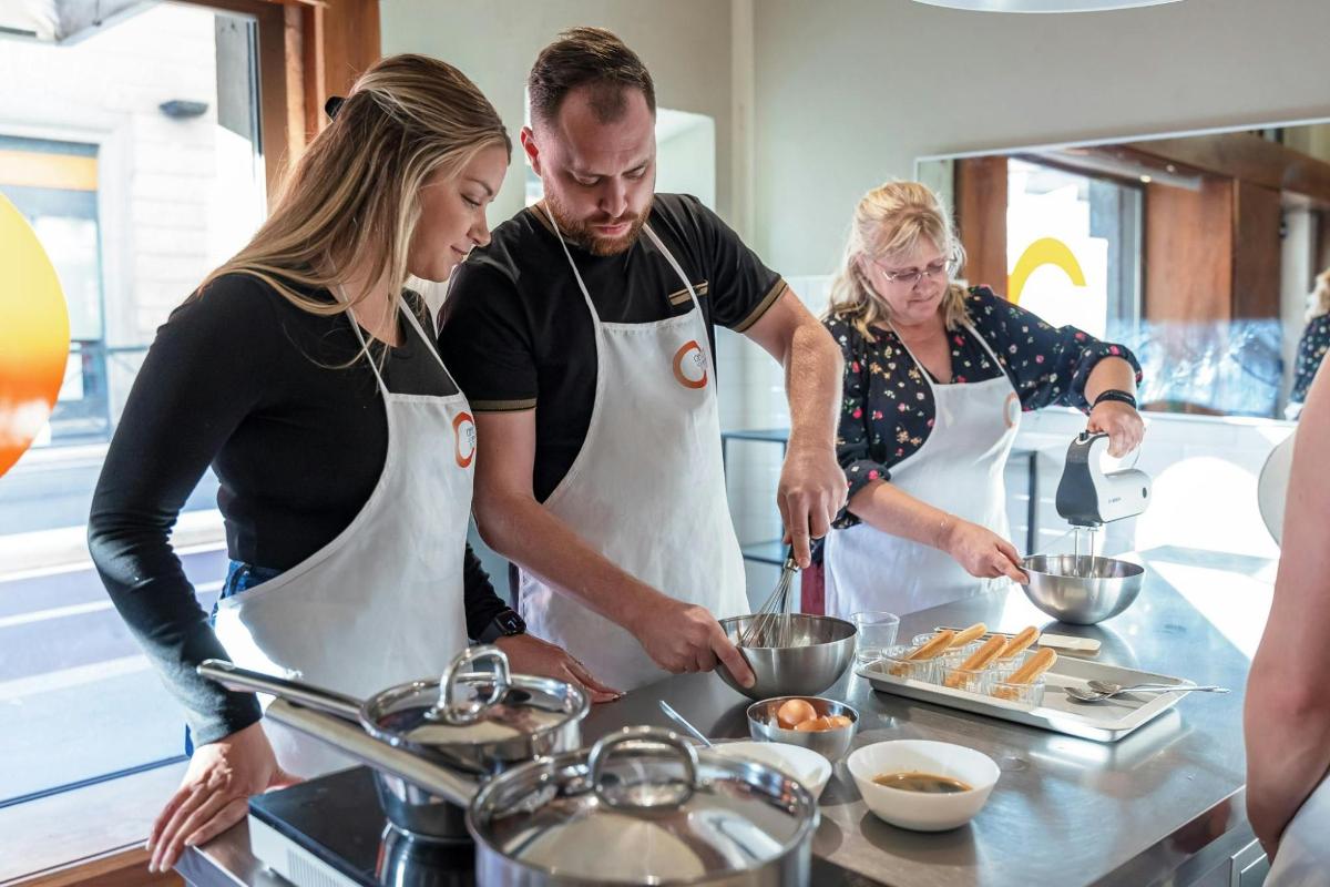 a group of people preparing food in a kitchen