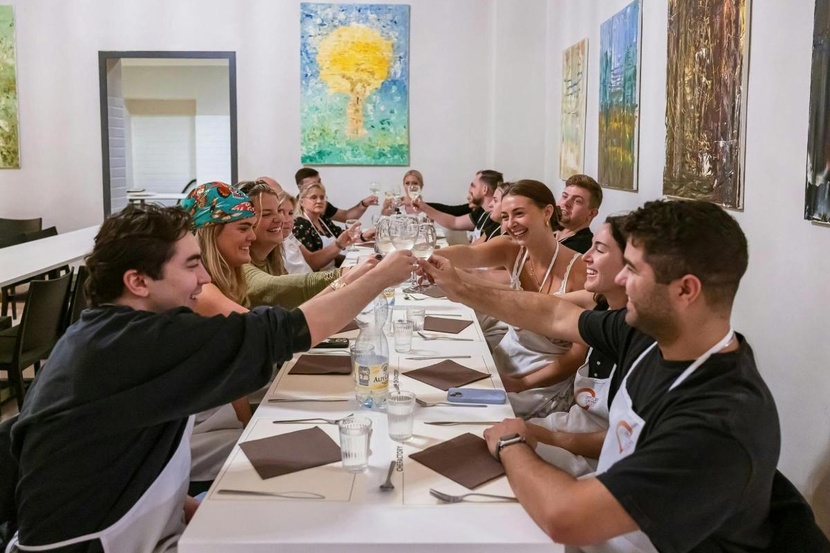 a group of people sitting around a table with their hands