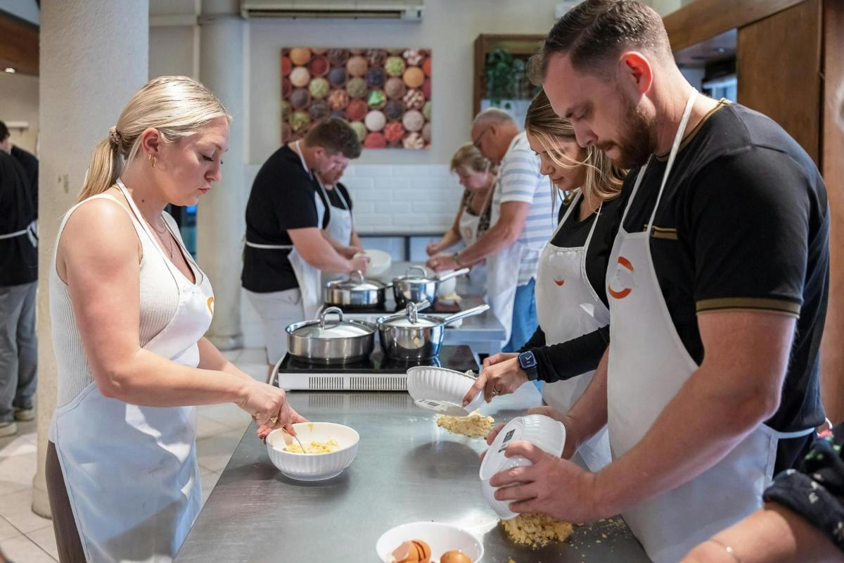 a group of people in a kitchen preparing food