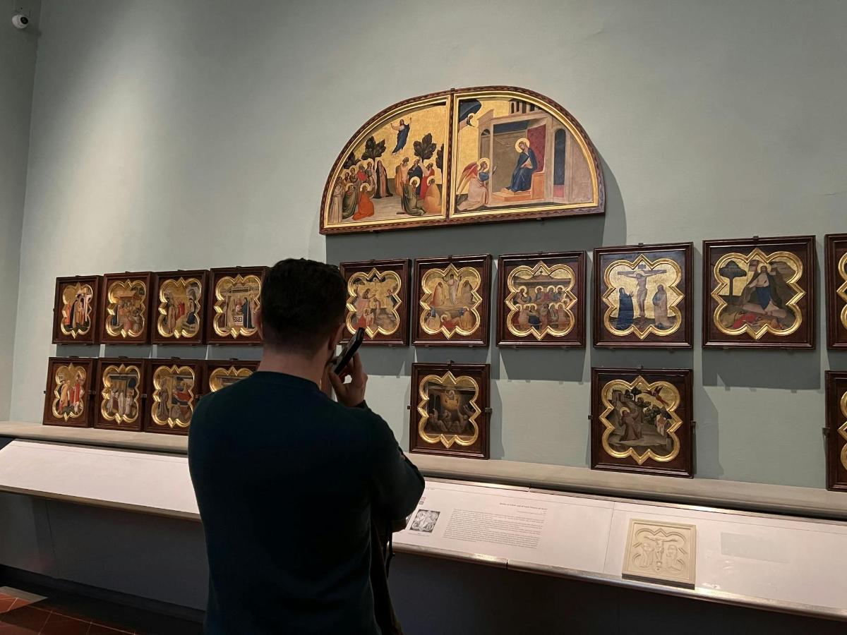 a man taking a picture of a display in a museum