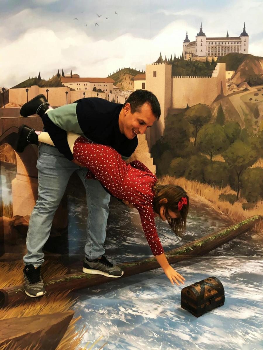 a man and a woman standing on top of a painting