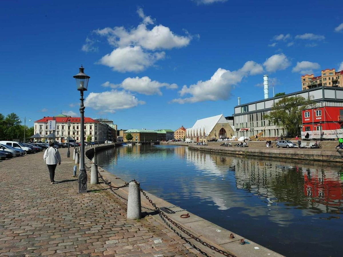 a person walking along a river in a city