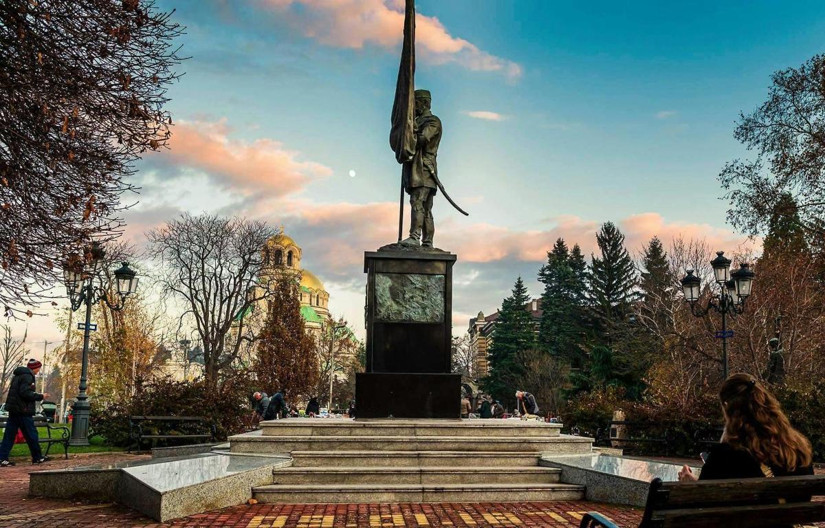 a statue of a woman standing on top of a monument