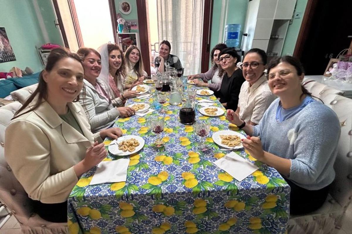 a group of people sitting around a table with food