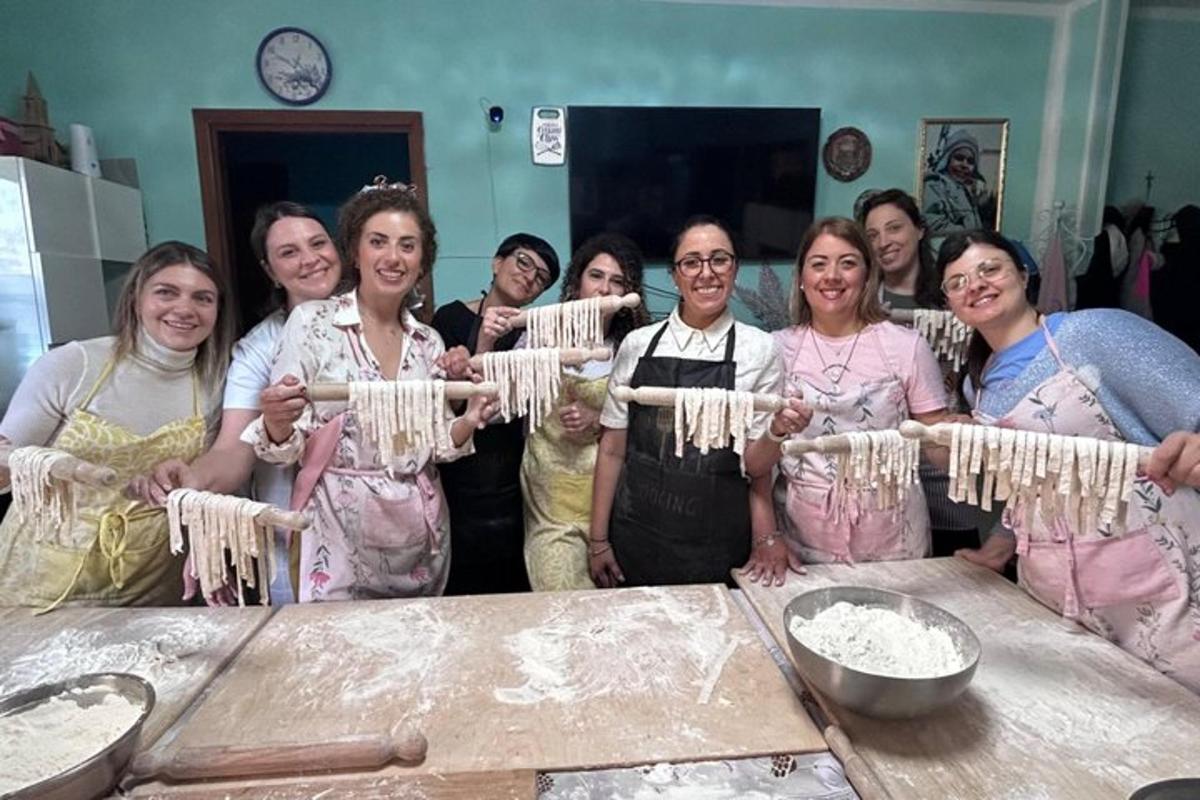 a group of women standing around a table with ingredients