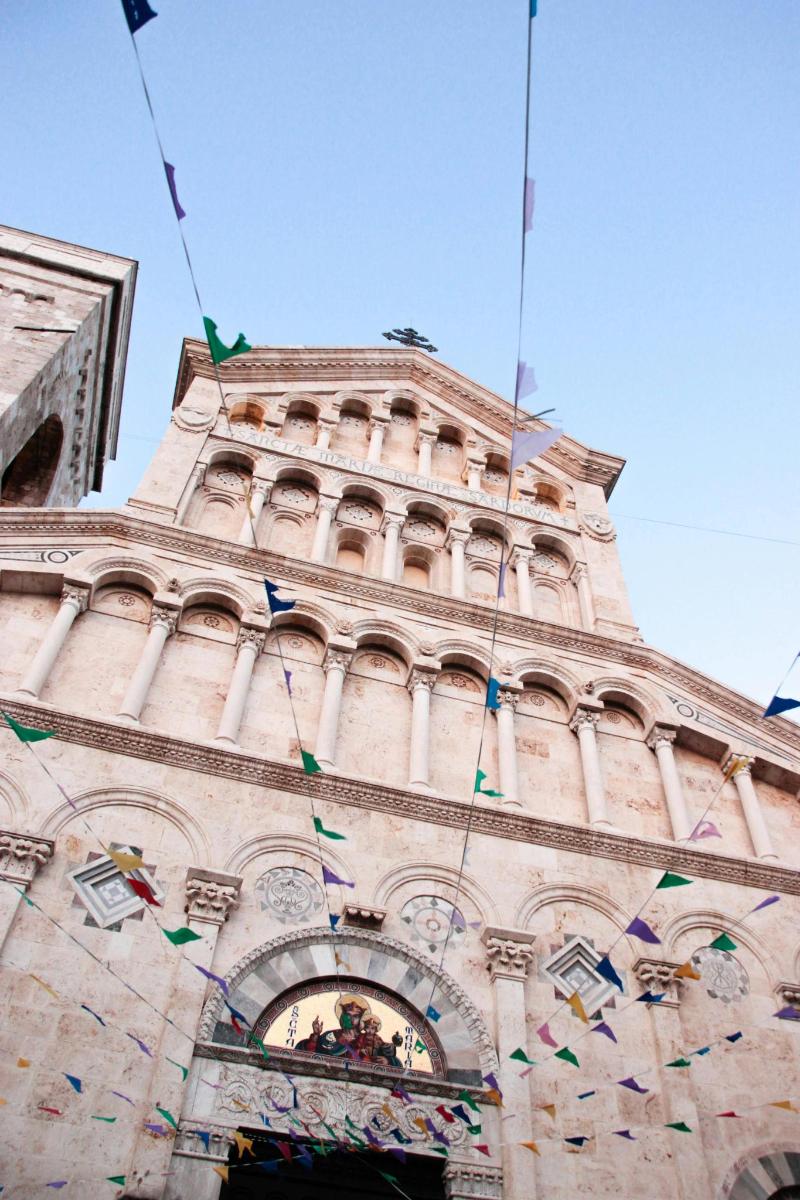 a tall building with flags hanging from it