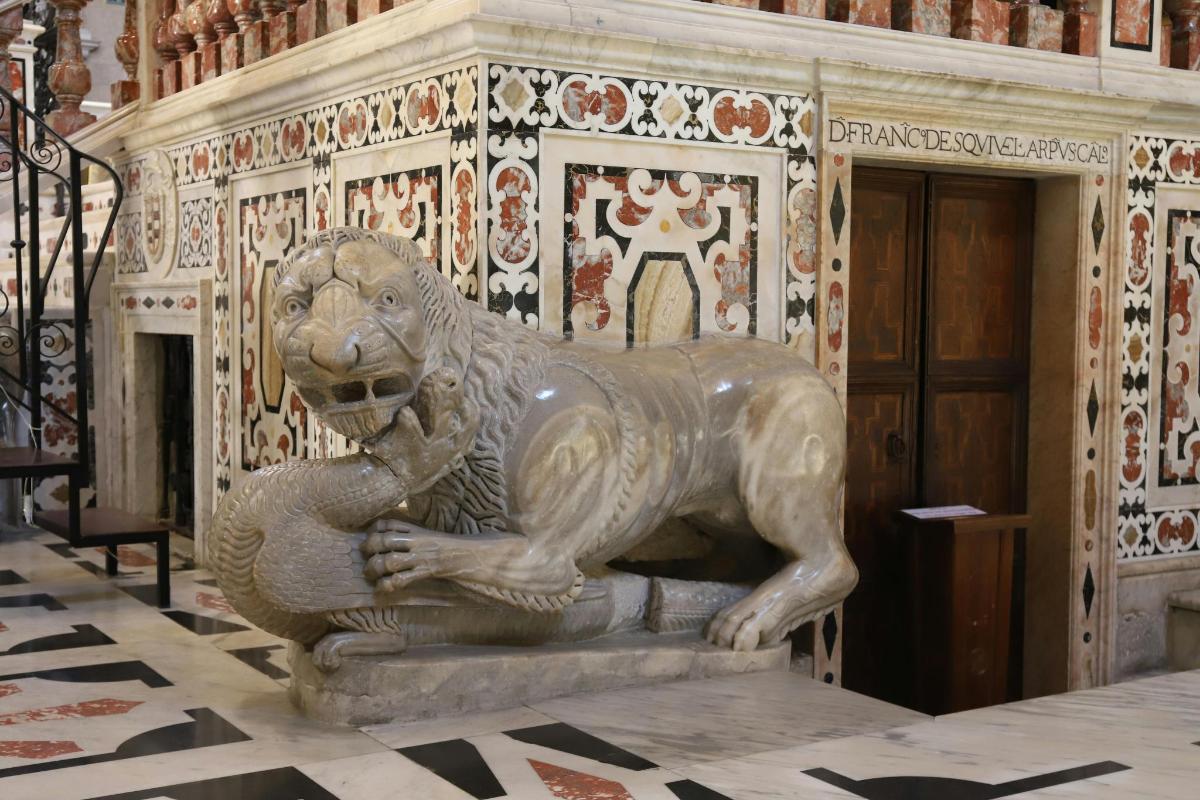 a statue of a lion sitting on a floor