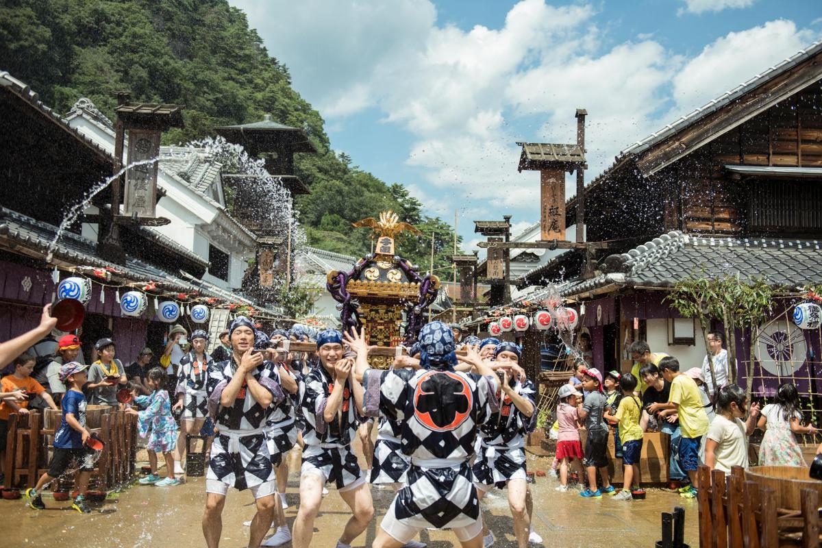 a group of people in costumes walking down a street