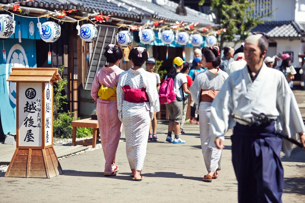 a group of people walking down a street